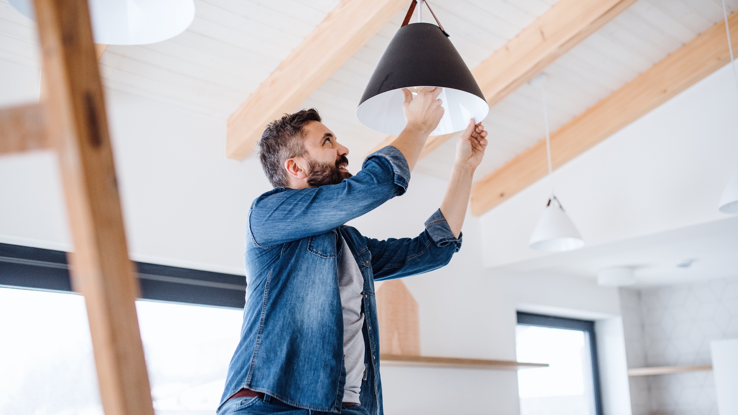 Person installing LED bulb in light