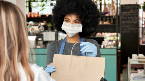 Small business owner serving a customer