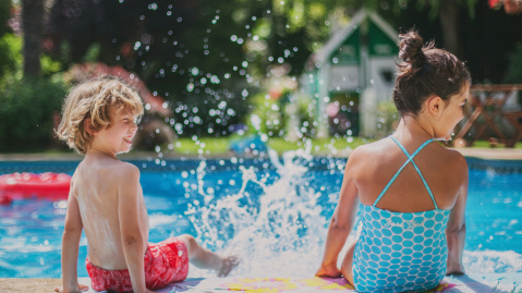 Two children playing in a pool