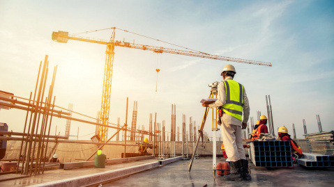 Workers on construction site with crane